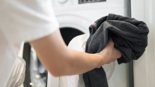 Man washing clothes in washing machine