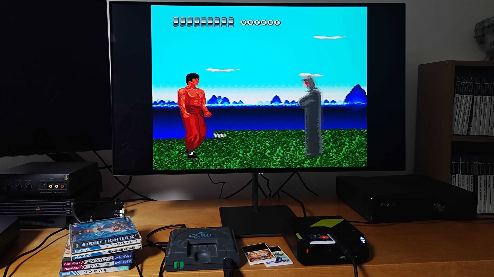Hyperkin Retron GX running The Kung Fu next to PC Engine beneath monitor.