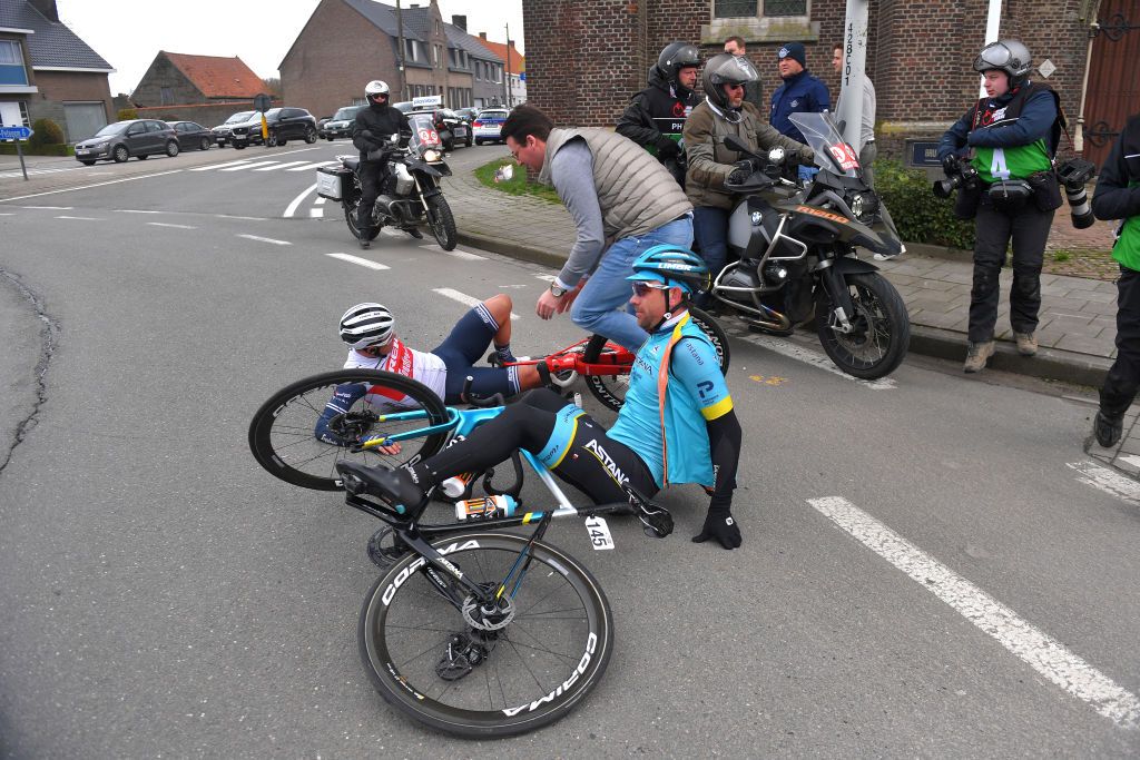 KUURNE BELGIUM MARCH 01 Emils Liepins of Latvia and Team TrekSegafredo Dmitriy Gruzdev of Kazakhstan and Astana Pro Team Crash Fans Public during the 72nd KuurneBrusselKuurne 2020 a 201km race from Kuurne to Kuurne KBK20 KuurneBxlKuurne KBK on March 01 2020 in Kuurne Belgium Photo by Tim de WaeleGetty Images