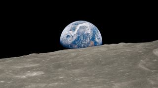 Earth rising above surface of the moon's surface - a photograph popularly known as Earthrise
