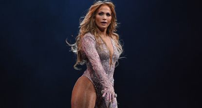 Jennifer Lopez performs onstage in a glittery bodysuit similar to the one she wore at the Elie Saab show