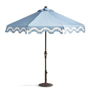 A backyard umbrella with scallop edges
