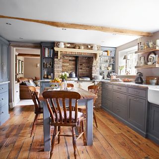Country style kitchen with wooden floors and blue cabinetry