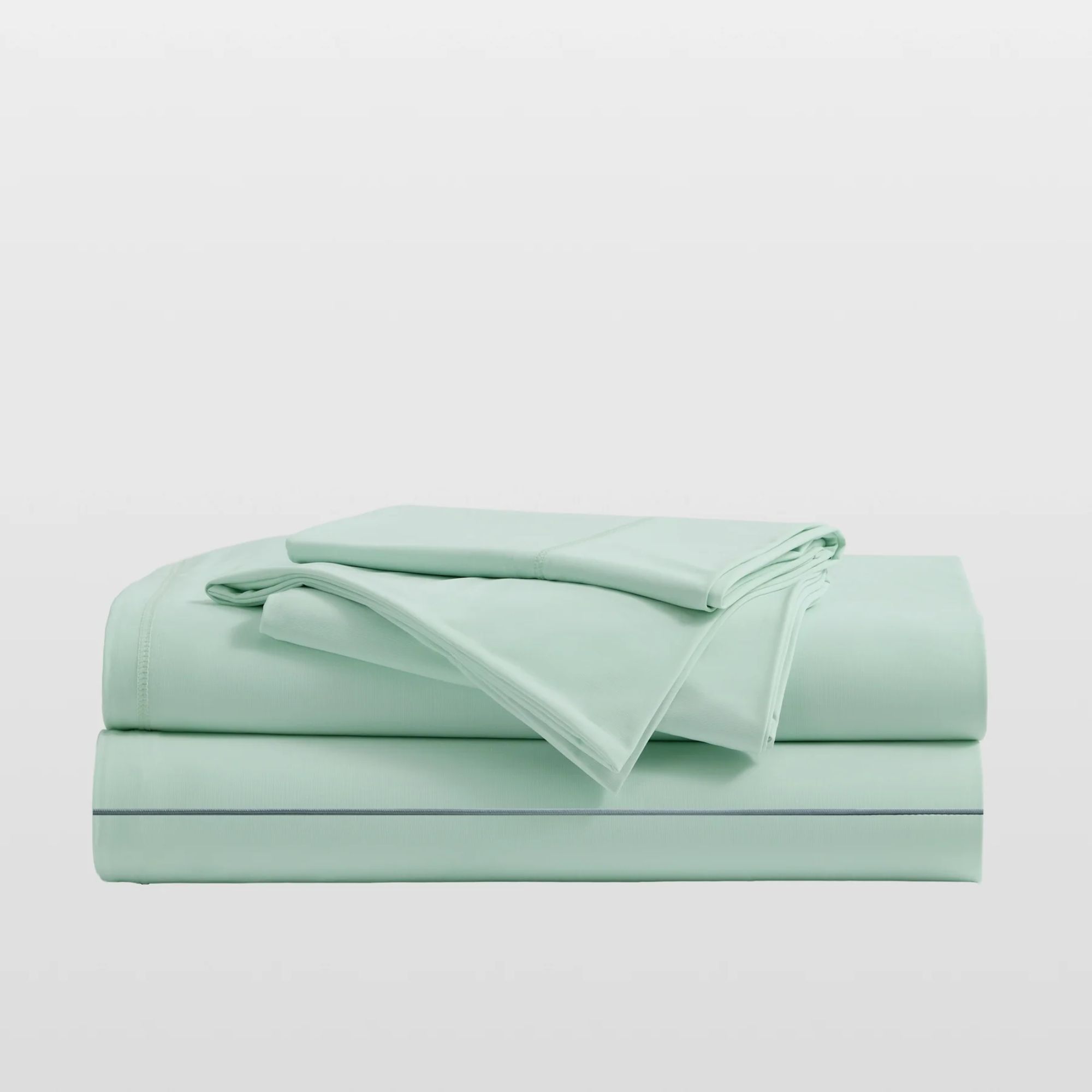 Mint green Breescape cooling sheets folded up in a pile