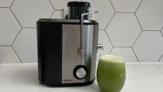 The Bagotte DB-001 juicer nexyt to a glass of green juice prepared in the appliance
