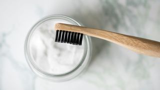 Top mistakes when brushing your teeth - toothbrush with pot of baking soda