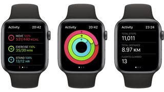 Three Apple Watches side by side, showing the Fitness app in watchOS 9.