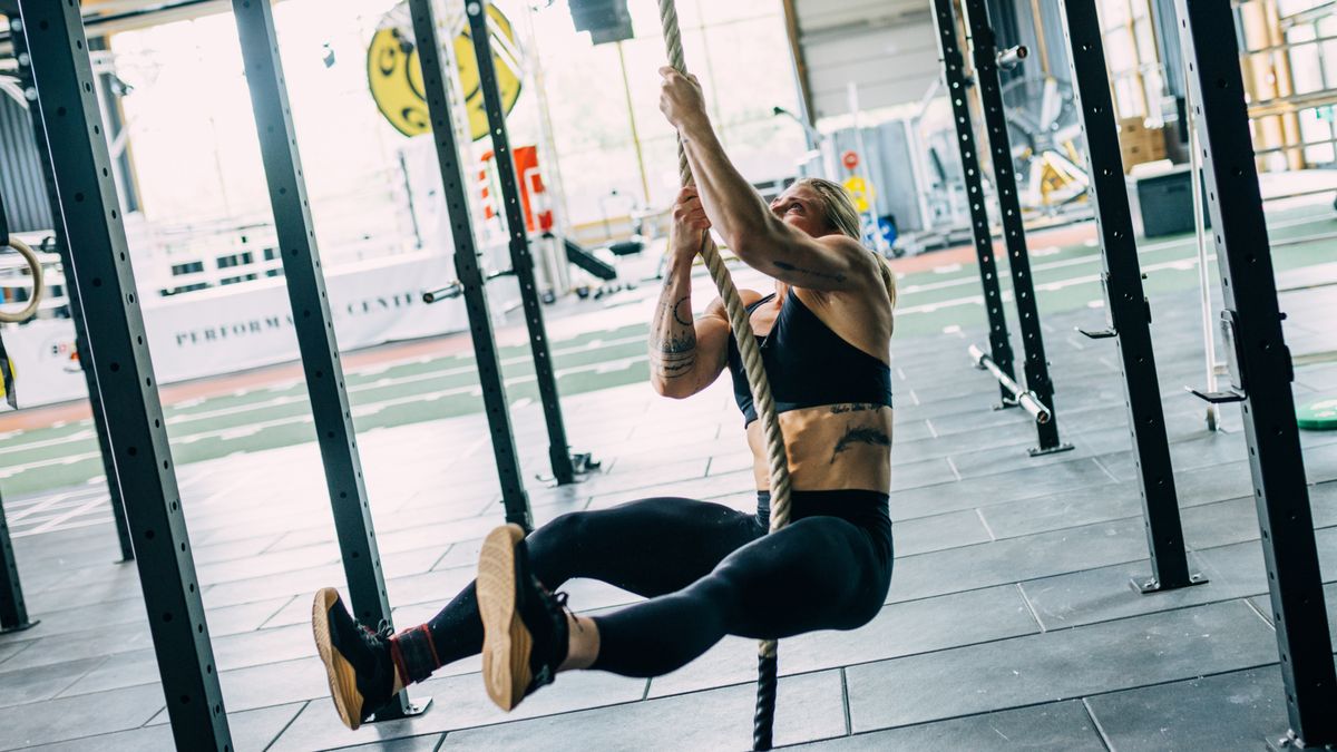 CrossFit athlete Emma Tall performing a hands-only rope climb 