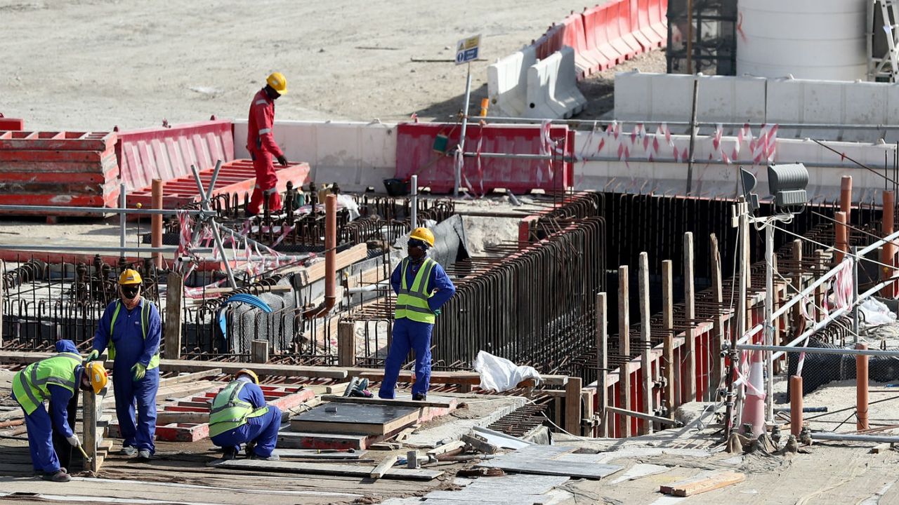 Workers at the construction site of the Al Bayt Stadium in Qatar