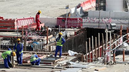 Workers at the construction site of the Al Bayt Stadium in Qatar