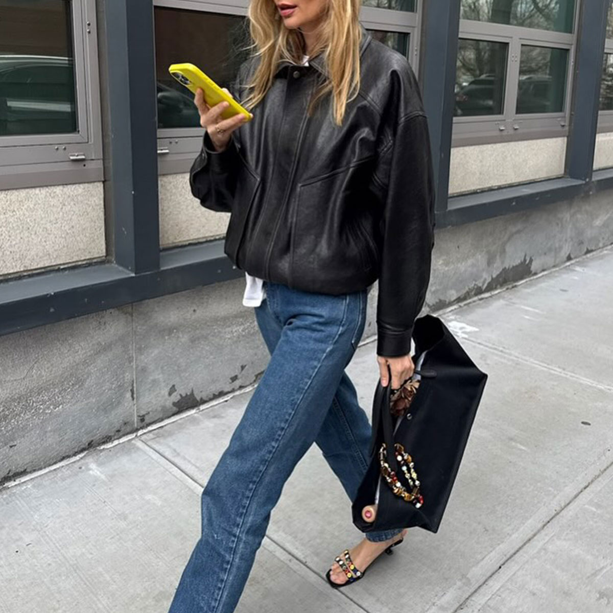 @courtneygrow outfit black leather jacket, blue jeans, the row idaho bag with charm