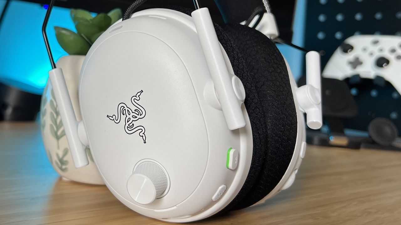 Side of Razer BlackShark V3 Pro earcup on a wooden desk