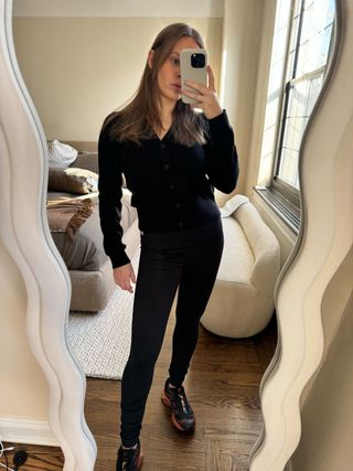 Nikki wears Nordstrom's Zella leggings with a black cardigan.