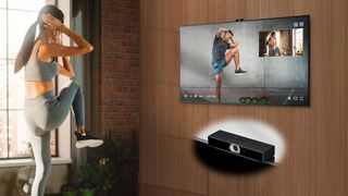 A woman exercises in front of an LG TV