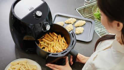 Girl using an air fryer