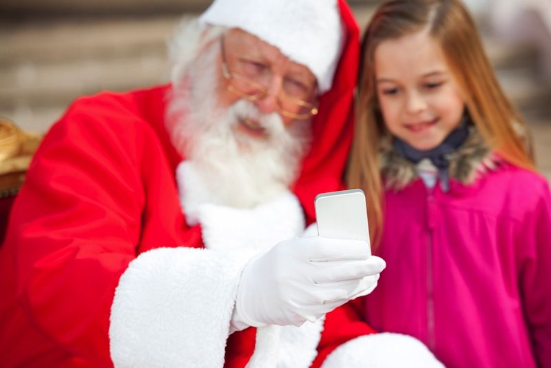 Santa and child take a cell phone picture