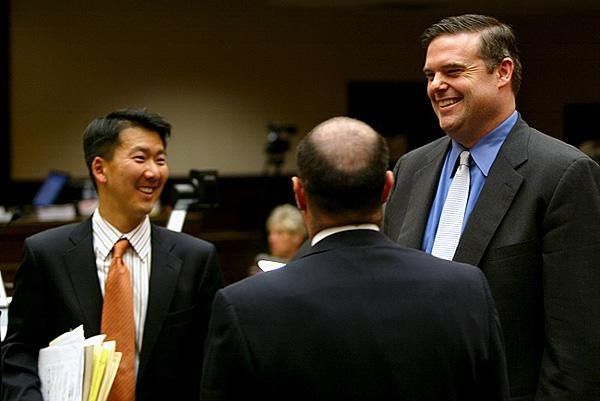 Both sides' lawyers have a small laugh