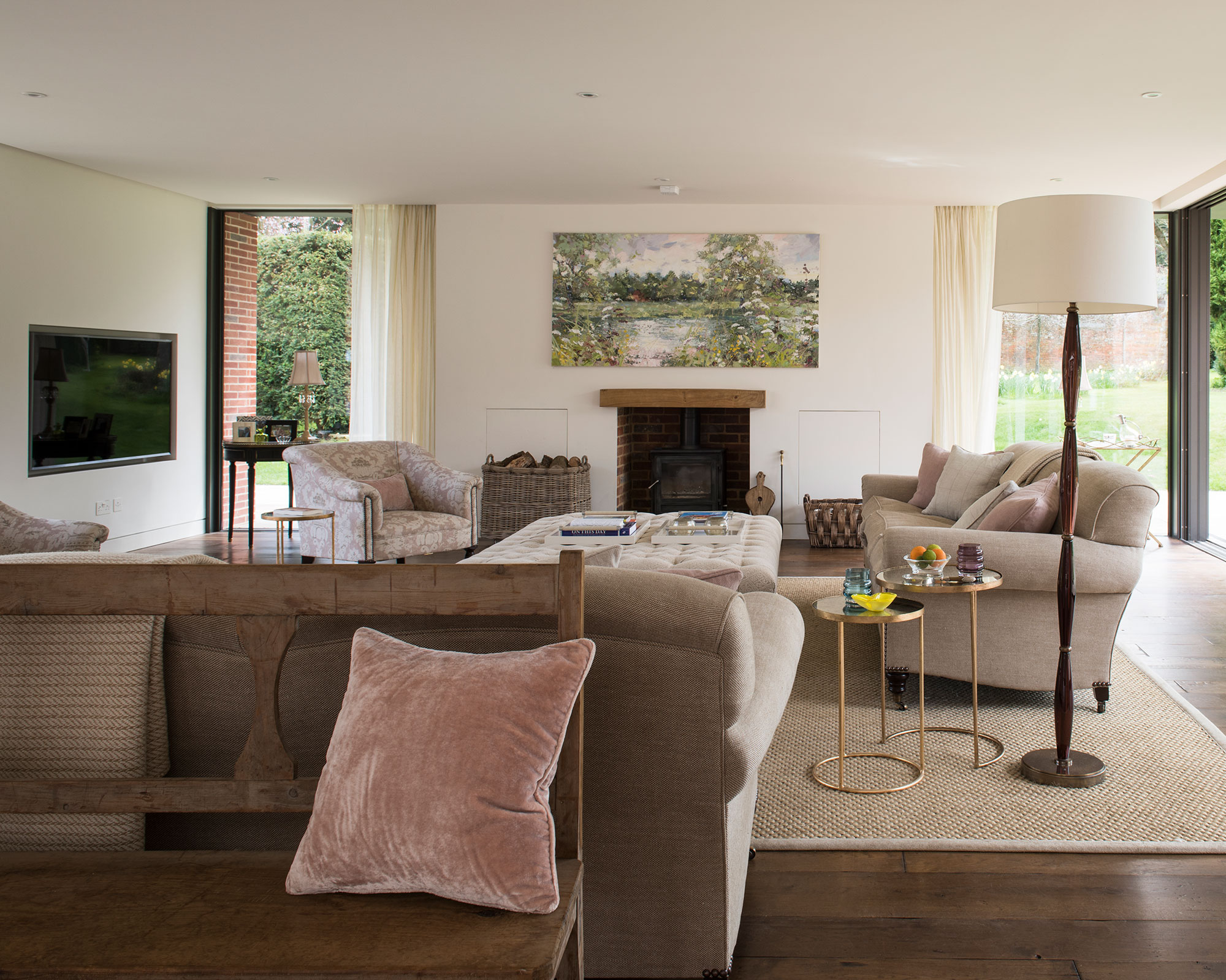 Open plan living room with neutral decor and wall mounted TV