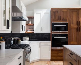 modern kitchen with white and wooden cabinets with black hardware