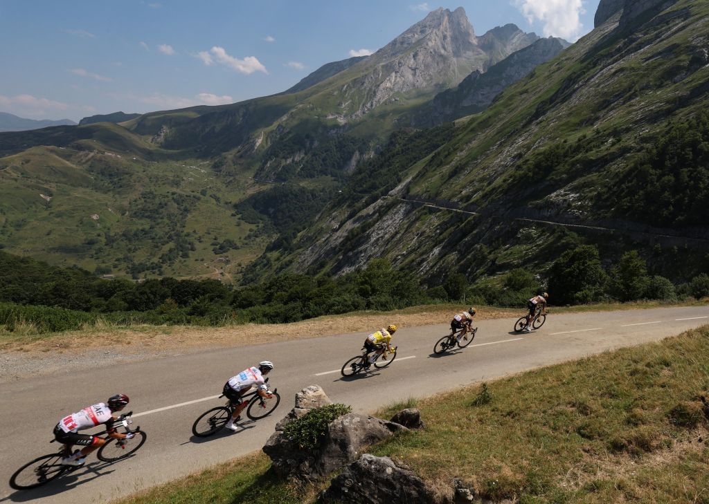 JumboVisma teams Belgian rider Nathan Van Hooydonck R JumboVisma teams American rider Sepp Kuss 2nd R JumboVisma teams Danish rider Jonas Vingegaard wearing the overall leaders yellow jersey C UAE Team Emirates teams Slovenian rider Tadej Pogacar wearing the best young riders white jersey 2nd L and UAE Team Emirates teams American rider Brandon McNulty L cycle in the descent of Col de Spandelles during the 18th stage of the 109th edition of the Tour de France cycling race 1432 km between Lourdes and Hautacam in the Pyrenees mountains in southwestern France on July 21 2022 Photo by Thomas SAMSON AFP Photo by THOMAS SAMSONAFP via Getty Images
