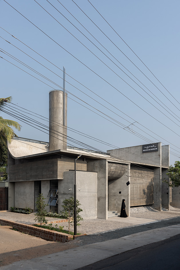 Brutalist mosque in Kerala, concrete structure against blue skies