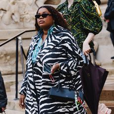 Gabriella wears zebra coat, jeans, two-toned heels and a black Alaia bag. 