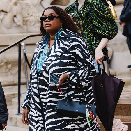 Gabriella wears zebra coat, jeans, two-toned heels and a black Alaia bag. 