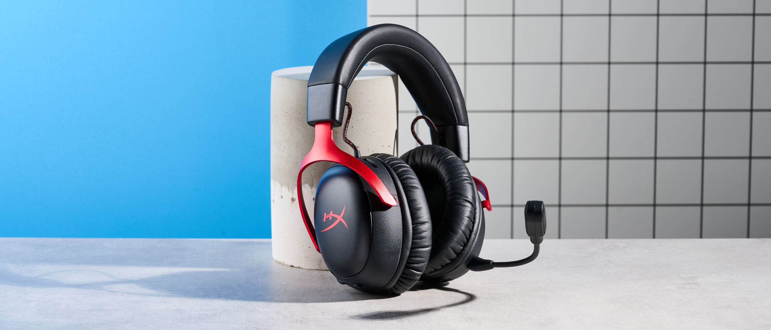 A black and red HyperX Cloud III S Wireless gaming headset