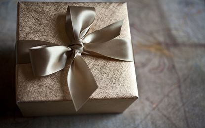 Gold Wrapping Paper and Bow made out of Beautiful Satin Ribbon makes any Gift even more Special