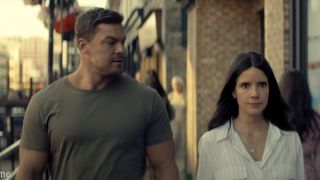 Alan Ritchson and Sonya Cassidy walking side by side on Reacher