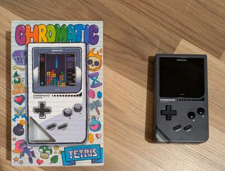 Modretro Chromatic review; a Game Boy like retro console on a wooden floor