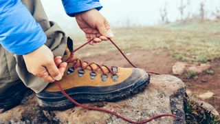 A hiker tying their laces