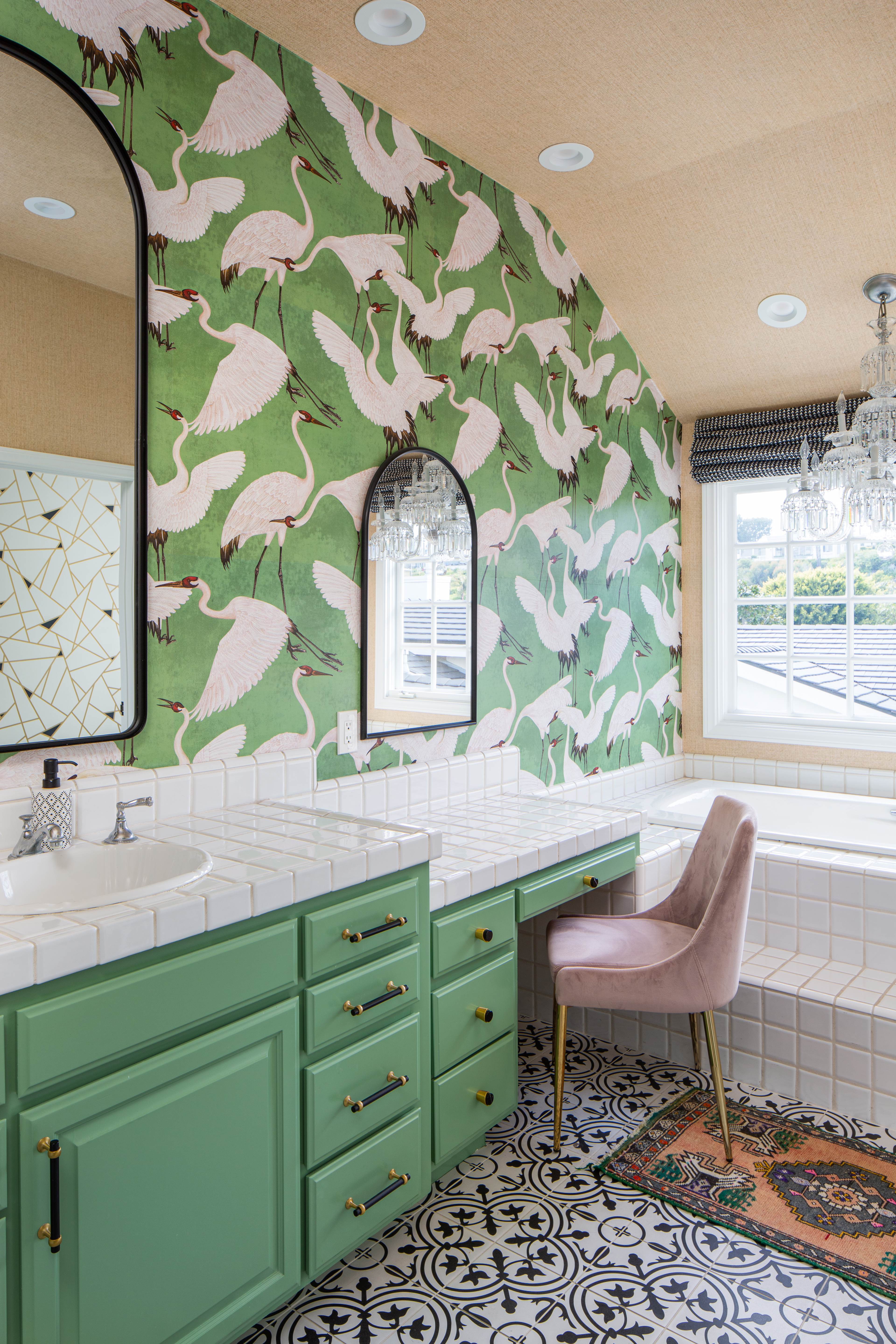 A bathroom in all green, with black patterned flooring