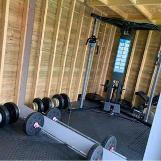 home gym with wooden wall and gym equipment