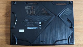 A black MSI GF63 Thin laptop on a wooden desk