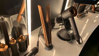 The Dyson Corrale next to the Dyson Supersonic on a styling bench