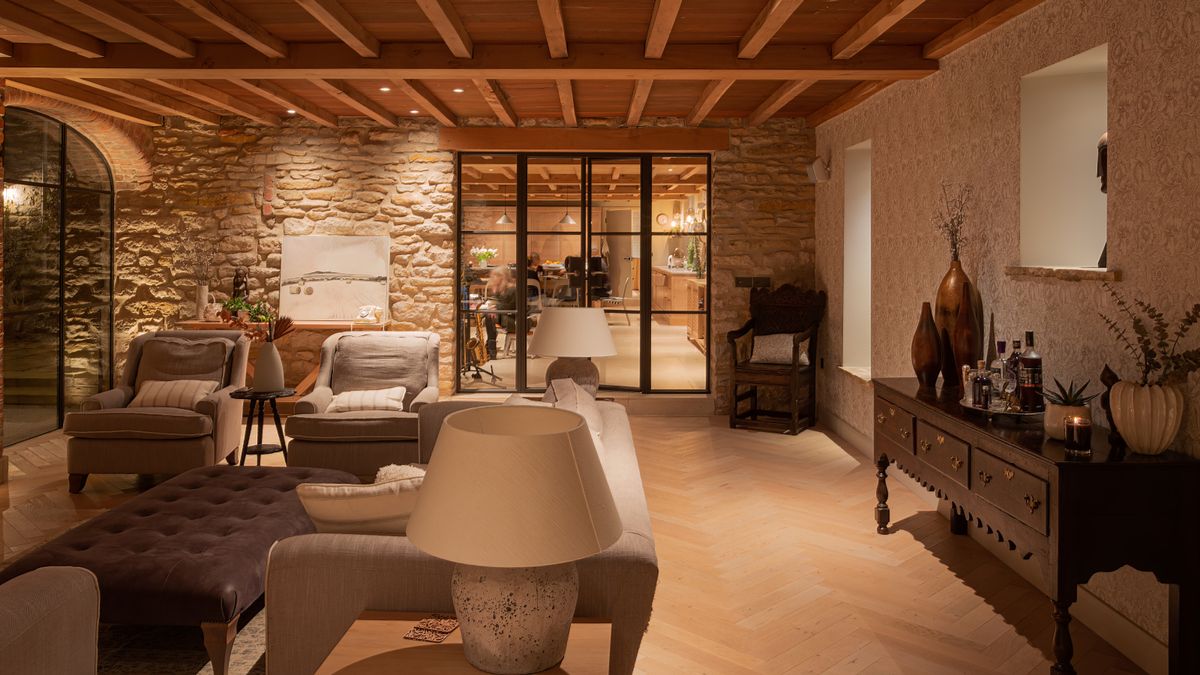 living room with wooden flooring and ceiling, cream sofas, wooden furniture and a range of different lighting