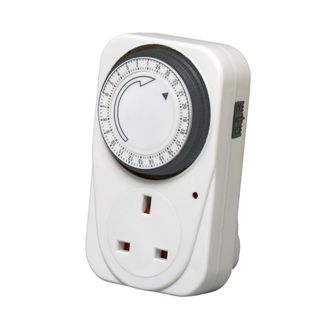 White plug socket timer with black dial with numbers on it