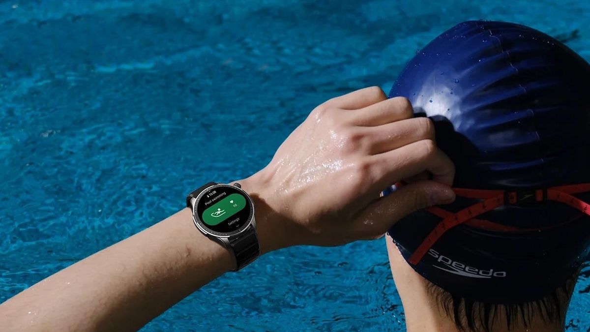 Amazfit GTR 4 smartwatch worn on a swimmer&#039;s wrist inside a pool.