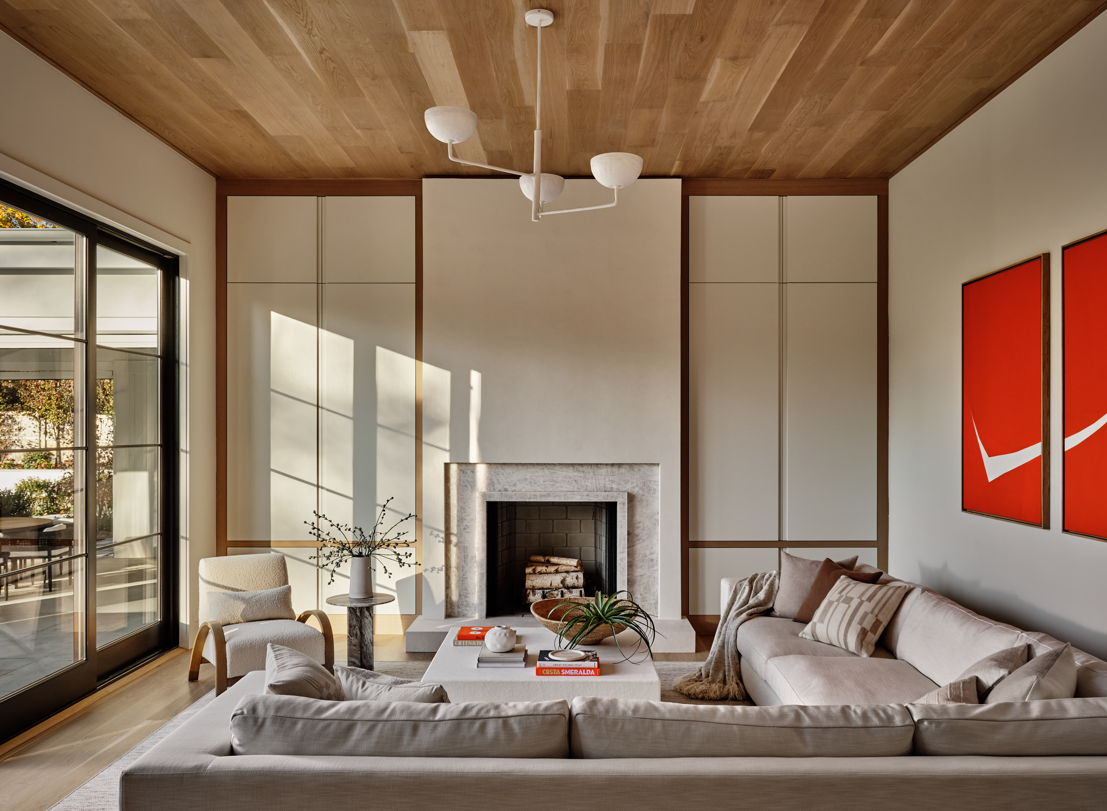 A large living room with a fireplace built with custom mill work, hiding the room's paraphernalia