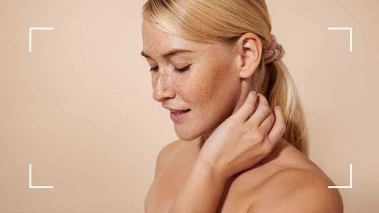 A blonde woman touching her neck, which is smooth after using the best neck cream for her skin type