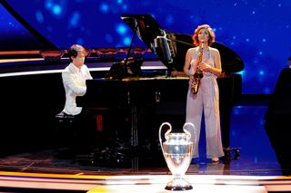Pianist Bruce Liu and saxophonist Asya Fateyeva perform prior to the UEFA Champions League 2023/24 Group Stage Draw at Grimaldi Forum on August 31, 2023 in Monaco, Monaco.