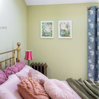 green bedroom with brass bed and pink bedding