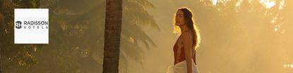 Woman standing at the pool admiring the view at Radisson hotels
