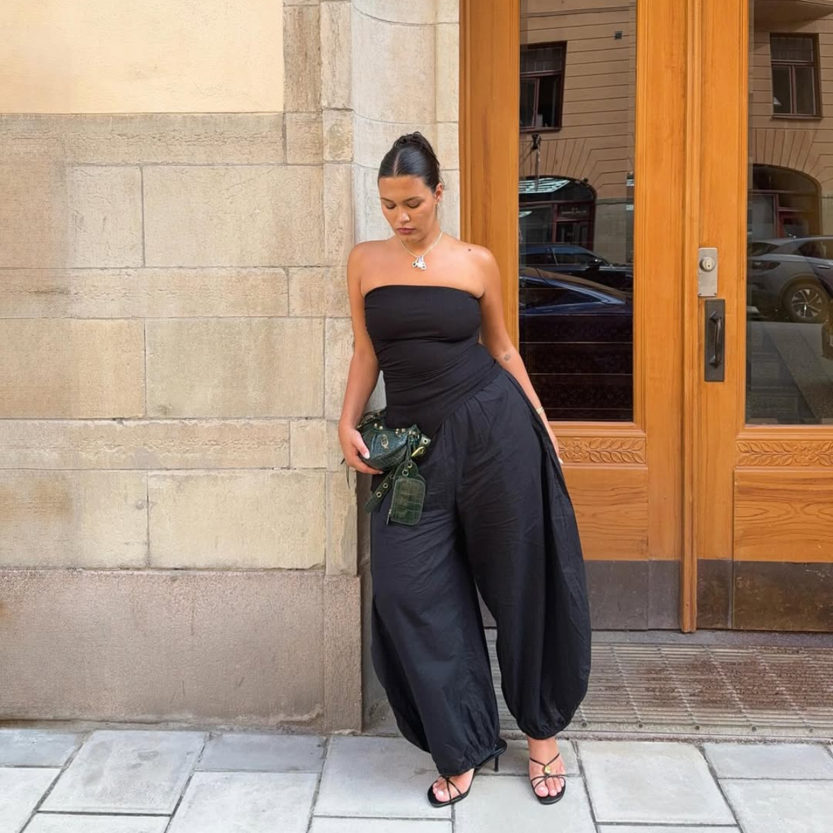Isabelle in black balloon trousers and strapless top