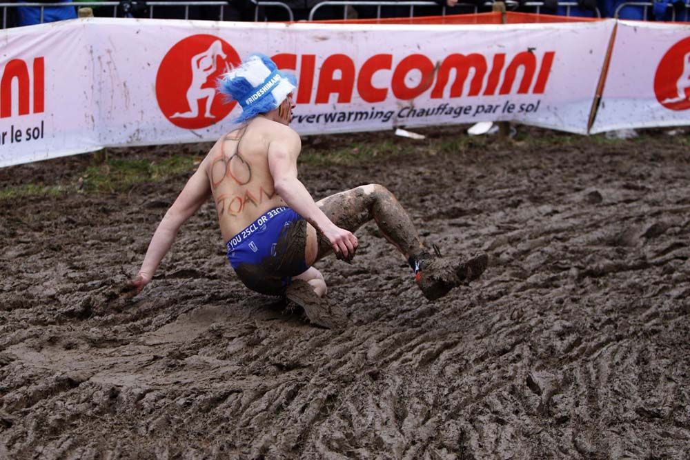A fan takes a tumble in the mud at the Worlds