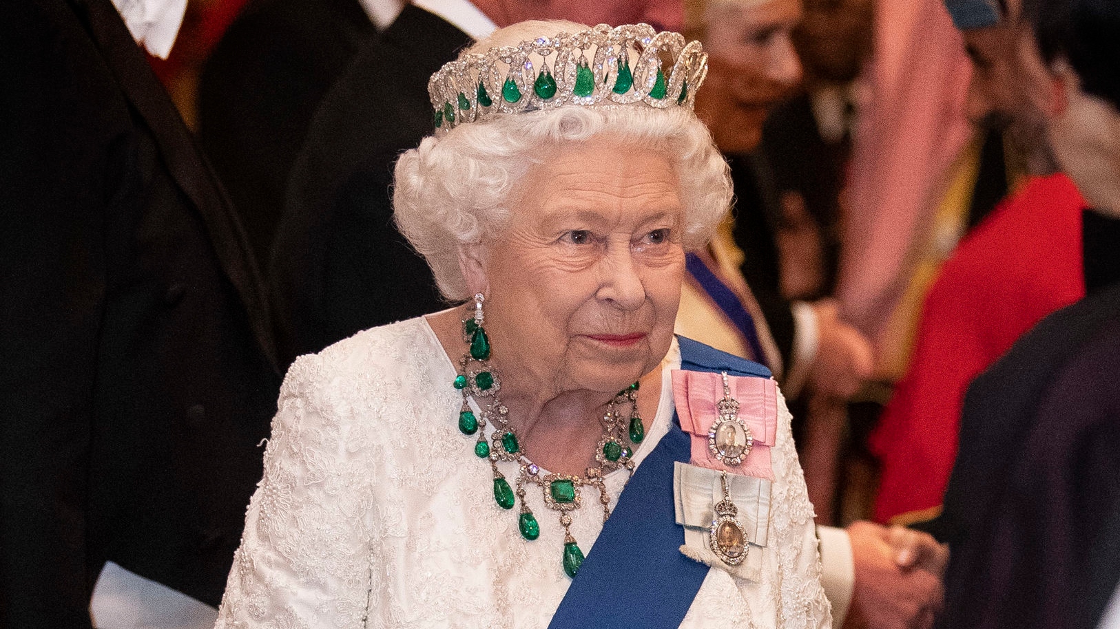 Queen Elizabeth II talks to guests at an evening reception for members of the Diplomatic Corps at Buckingham Palace on December 11, 2019