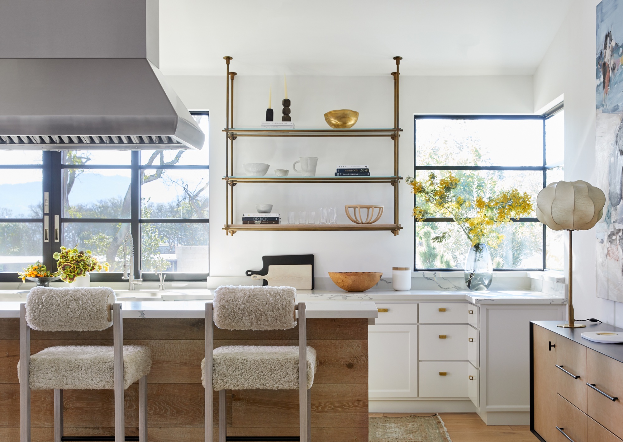 white kitchen with teddy bar stools and curved table lamp by K Interiors