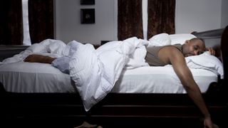 A man lying in bed in a deep sleep