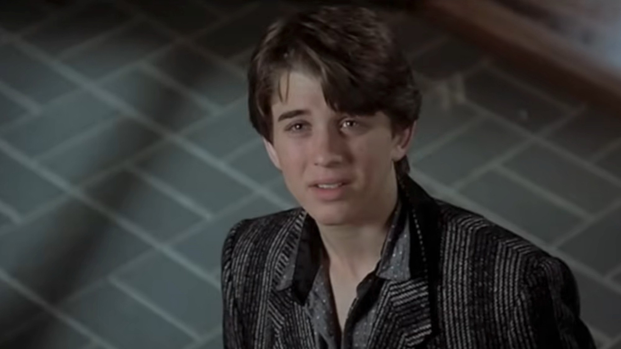 A close up on Ilan Mitchell-Smith looking a little worried in Weird Science